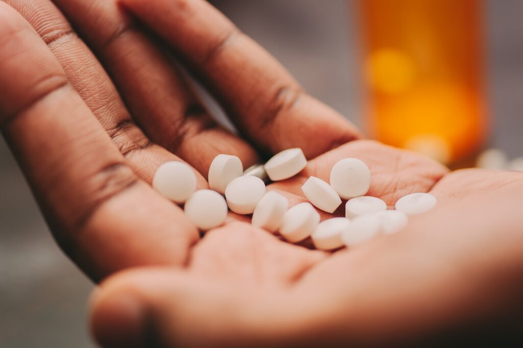 african american man holding handful of pills 2023 11 27 05 09 10 utc