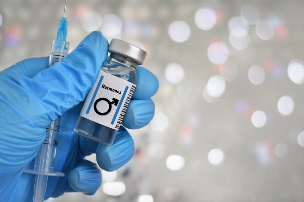 blue gloved hand holding a vial with male symbol 2024 04 30 17 50 57 utc