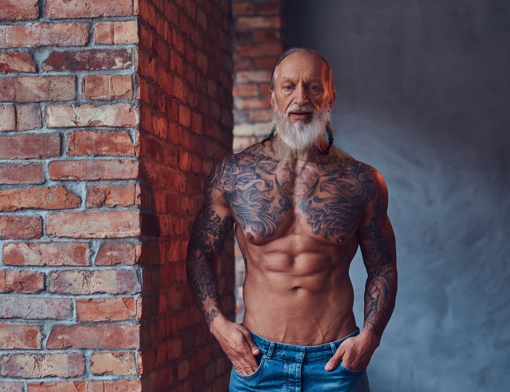 muscular elderly man with tattooed body indoors ro 2023 11 27 05 37 21 utc