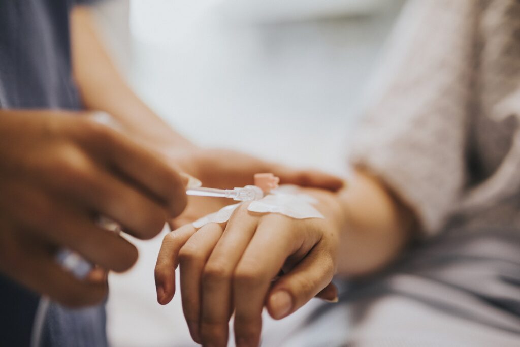 nurse applying an iv drip to a patient 2023 11 27 04 54 09 utc