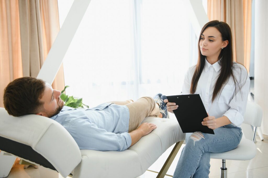 depressed man speaking to a therapist while she is 2023 11 27 05 05 13 utc